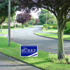 A custom campaign yard sign on the side of a road